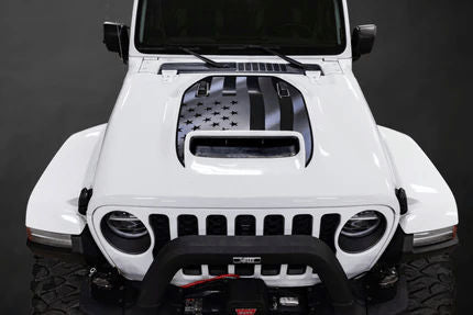 White Jeep with a custom black American flag hood sticker, adding a bold and rugged design to the vehicle.